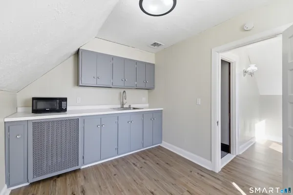 a kitchen with a sink a stove and cabinets