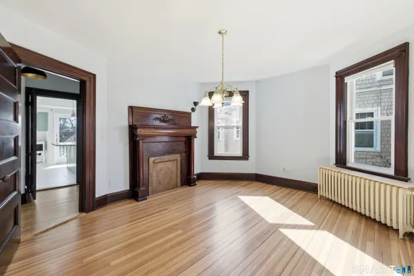 a view of a room with a window and wooden floor