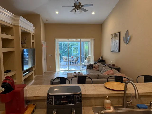 a kitchen with stainless steel appliances granite countertop a refrigerator a stove and a sink