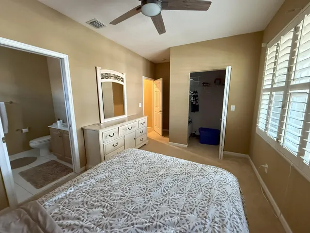 a bathroom with a granite countertop shower and a toilet