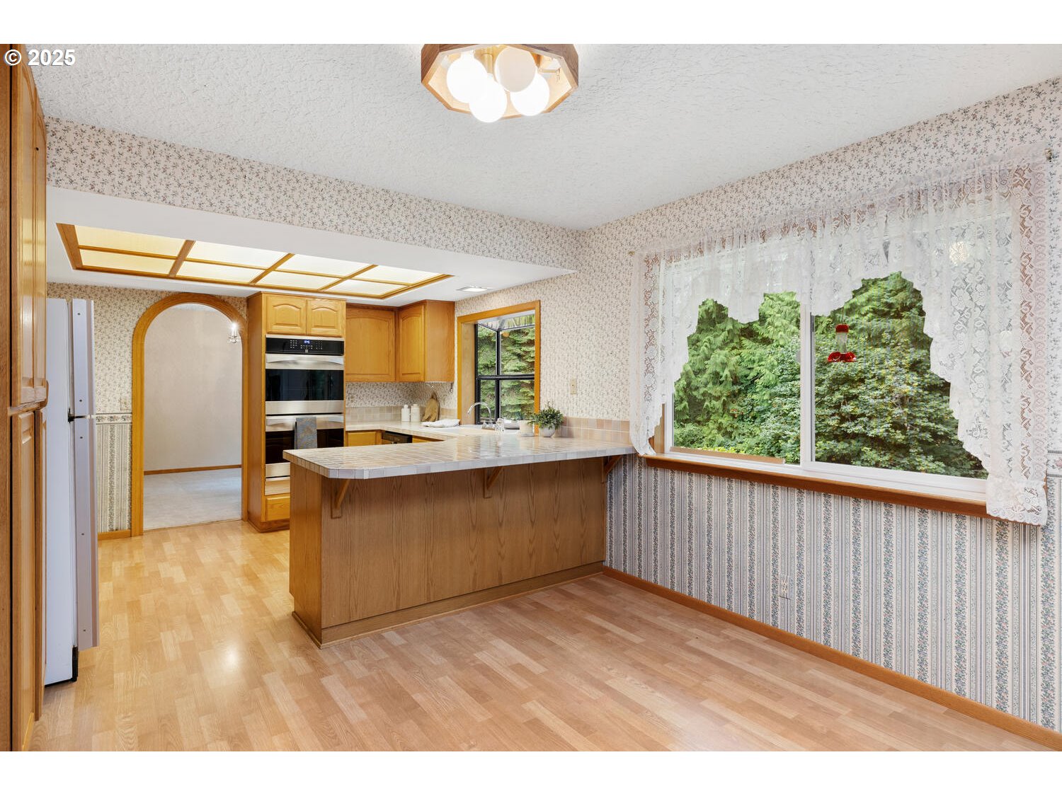 3208 Northwest 199th Street Ridgefield, WA 98642 - Photo 22 of 48 a kitchen with stainless steel appliances granite countertop a sink and a wooden floor