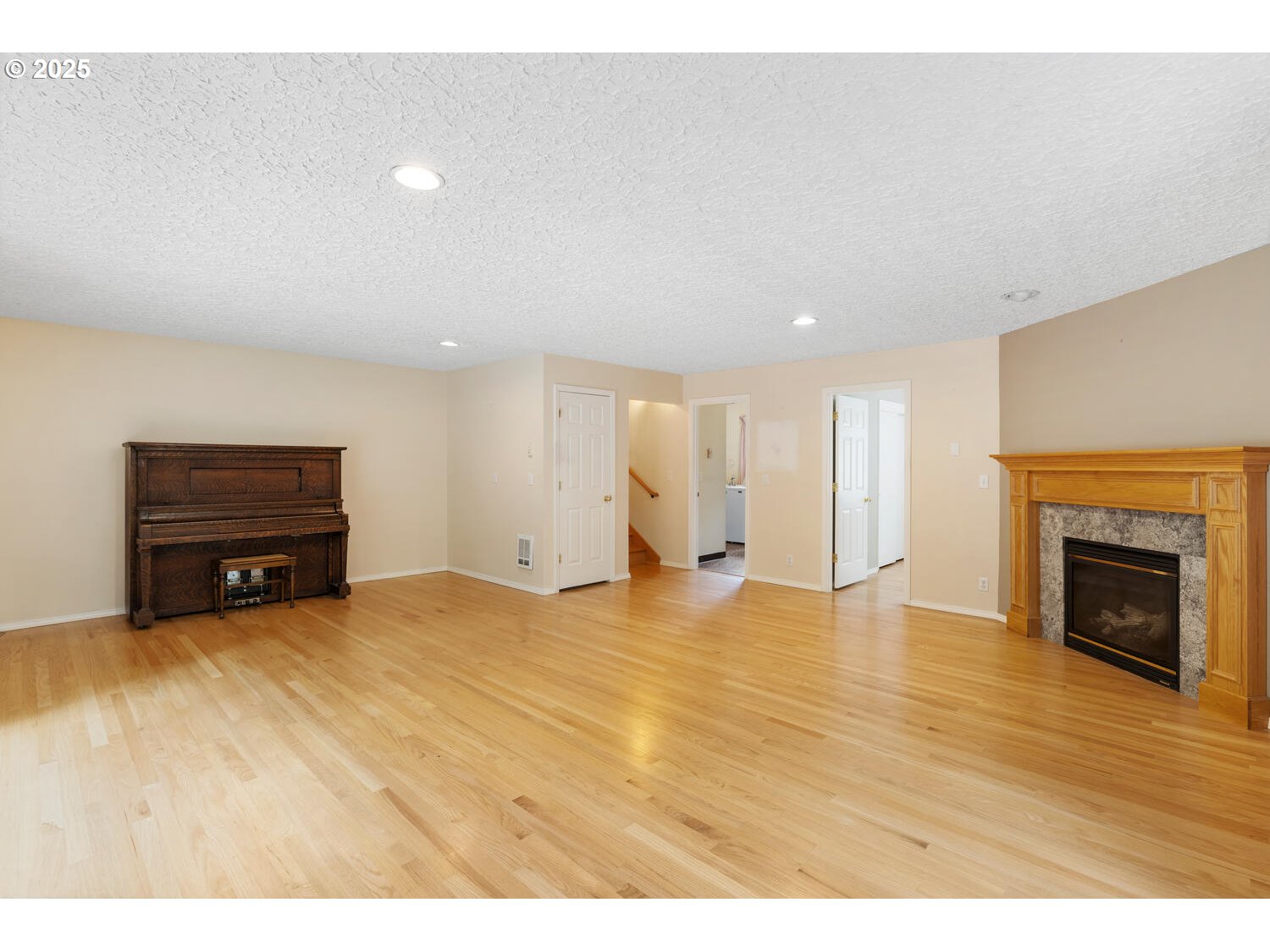 3208 Northwest 199th Street Ridgefield, WA 98642 - Photo 40 of 48 a view of an empty room with wooden floor fireplace and a window
