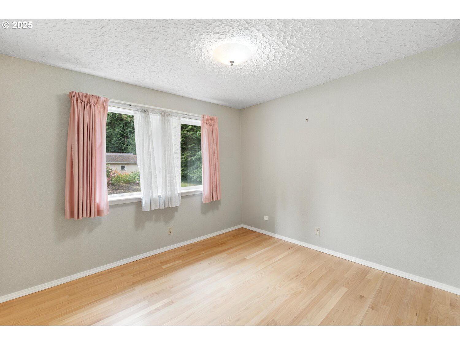 3208 Northwest 199th Street Ridgefield, WA 98642 - Photo 41 of 48 an empty room with wooden floor and windows