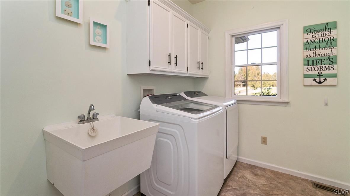 573 West Moorestown Road Nazareth, PA 18064 - Photo 18 of 46 a utility room with cabinets washer and dryer