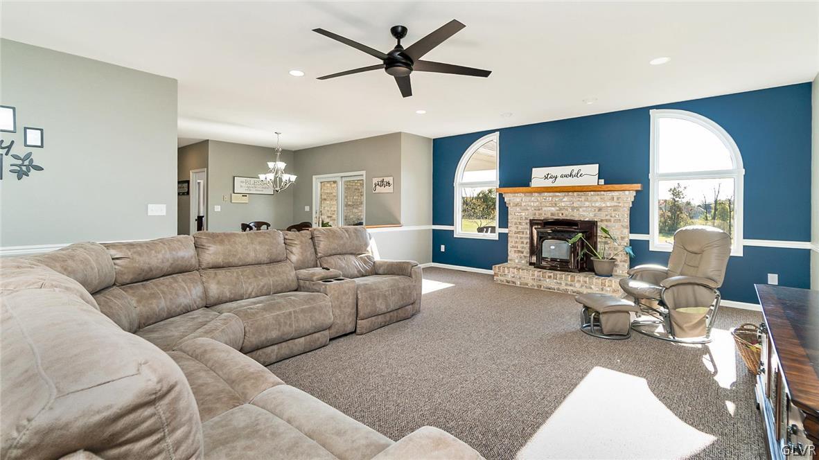 573 West Moorestown Road Nazareth, PA 18064 - Photo 7 of 46 a living room with furniture a fireplace and a flat screen tv