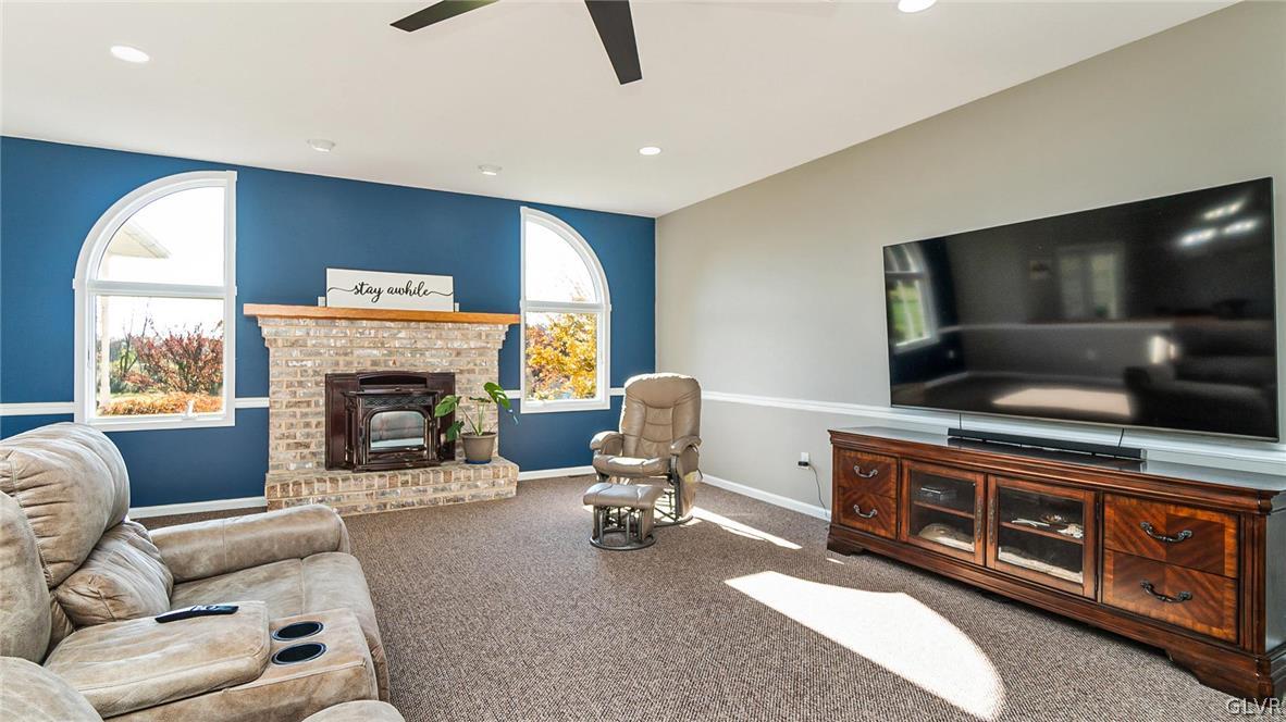 573 West Moorestown Road Nazareth, PA 18064 - Photo 8 of 46 a living room with furniture a flat screen tv and a fireplace