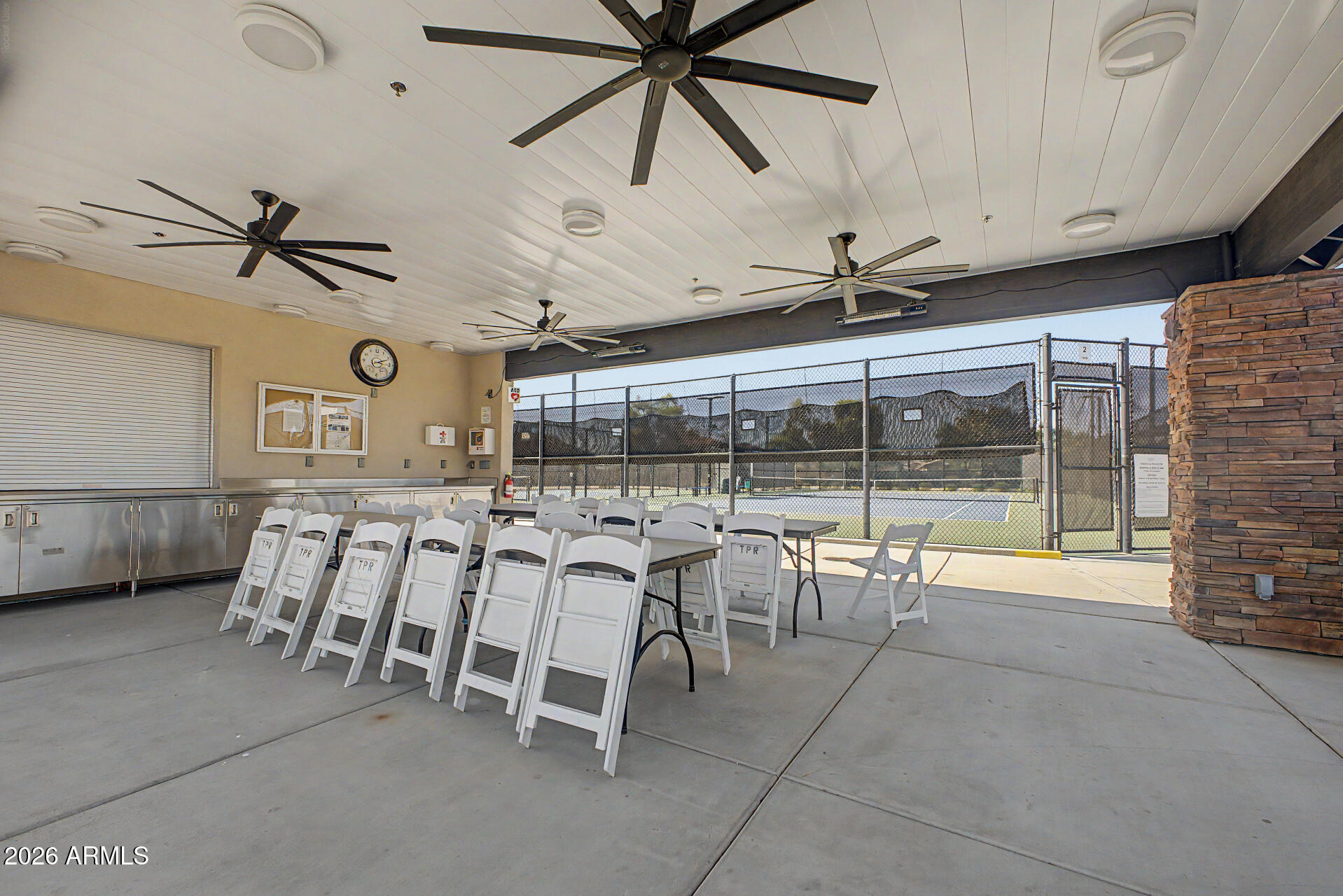 5090 South Ranger Trail Gilbert, AZ 85298 - Photo 45 of 50 a room with lots of white furniture a rug and a fan