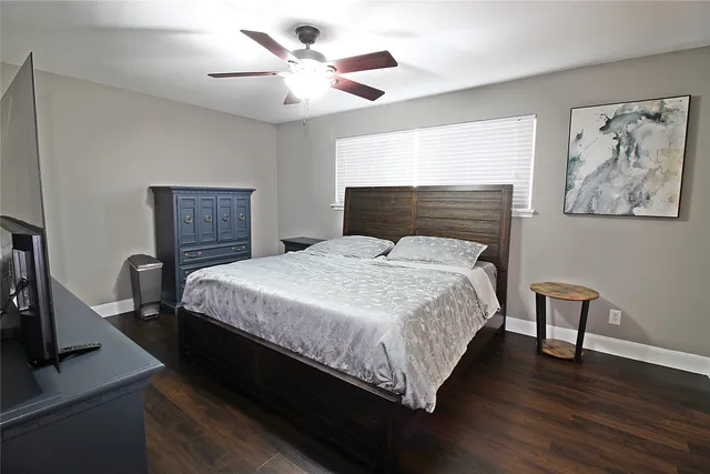 a bedroom with a bed a desk and chair