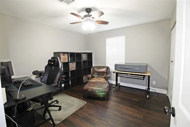a bathroom with a granite countertop sink toilet mirror and shower