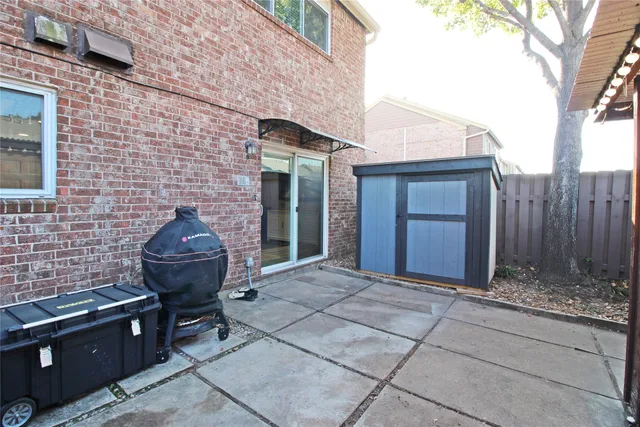 front view of a brick house with a yard
