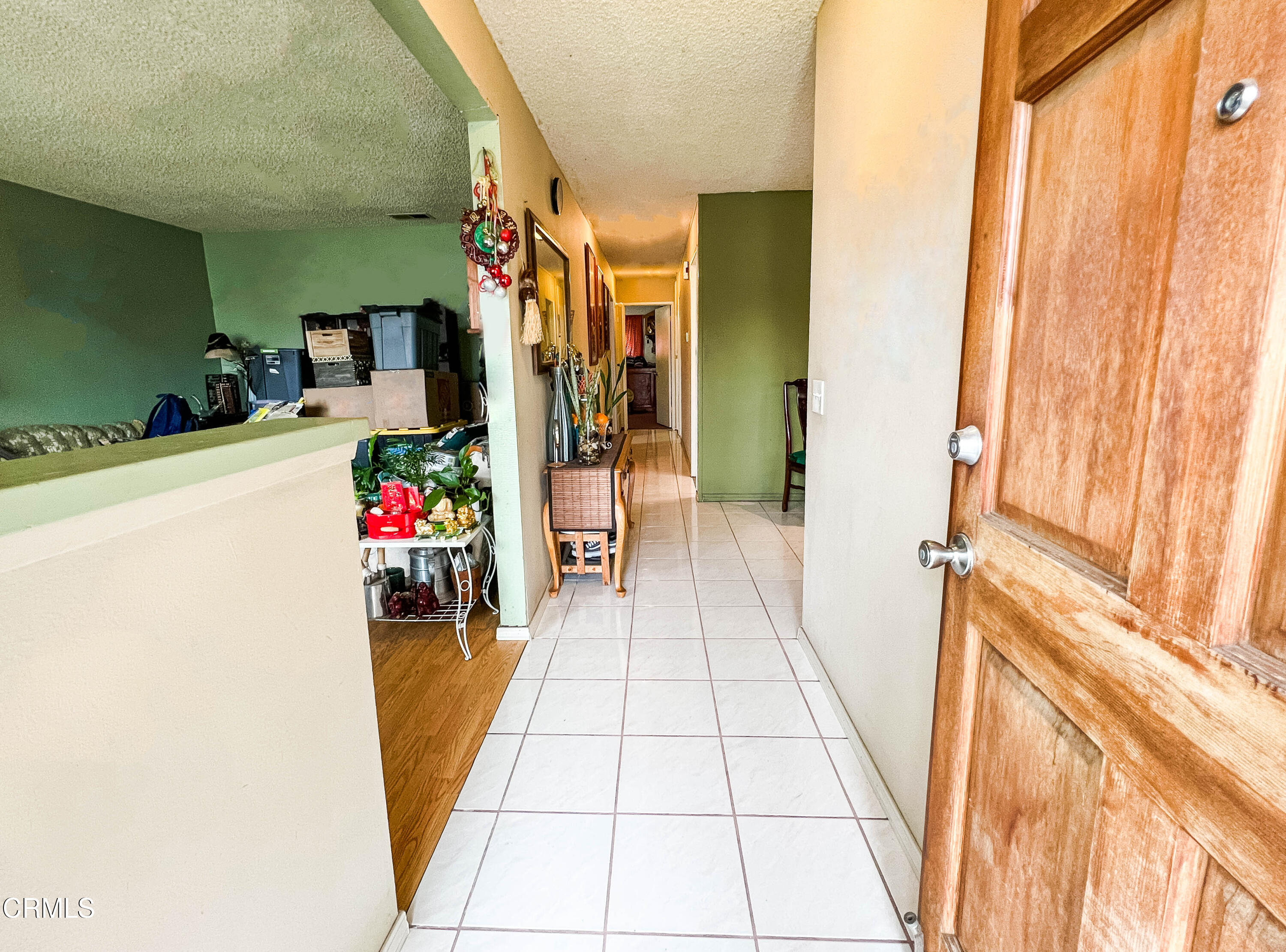 5001 Ivan Drive Oxnard, CA 93033 - Photo 2 of 16 a hallway with a dining table and chairs in a room