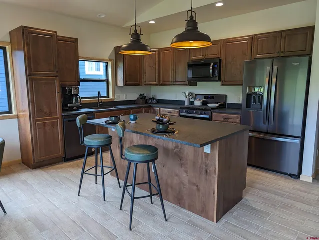 a view of a porch with furniture and a yard