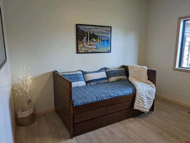a view of a hallway with a chandelier fan