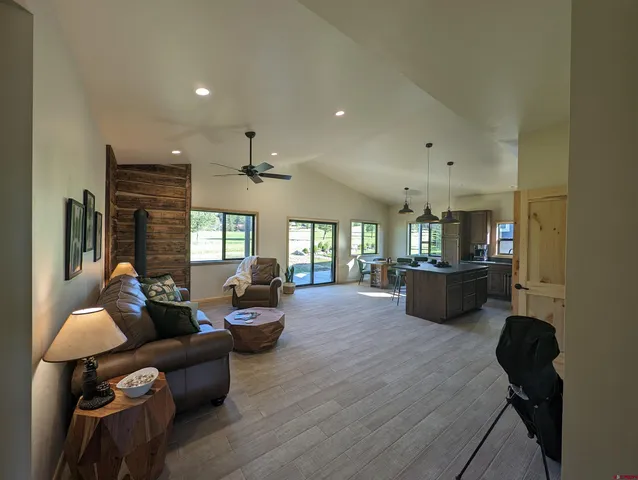 a kitchen with stainless steel appliances granite countertop a refrigerator a stove a sink and a microwave