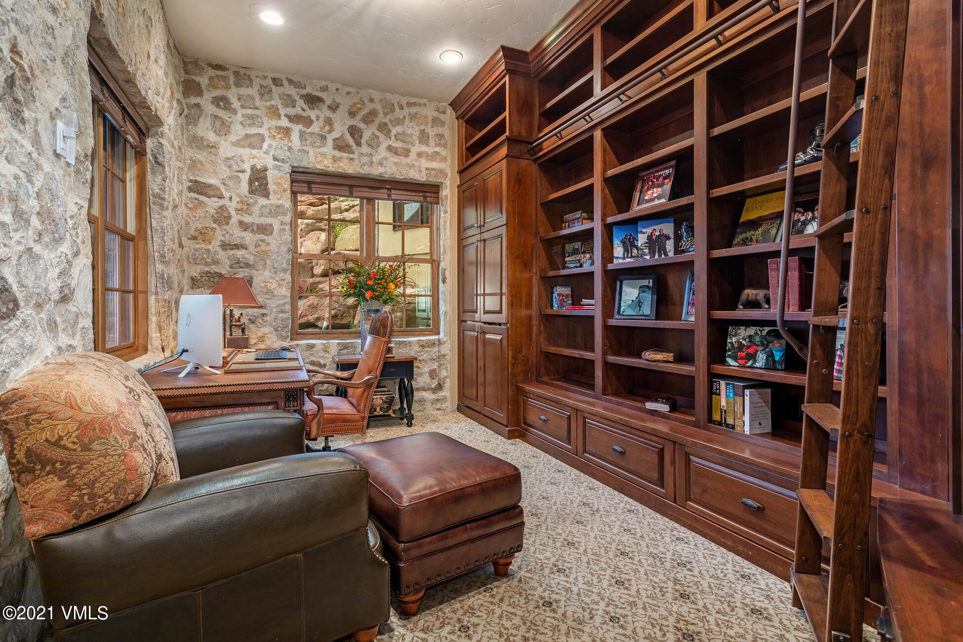 559 Eagle Drive Eagle-Vail, CO 81620 - Photo 28 of 50 a living room with furniture cabinets and a book shelf