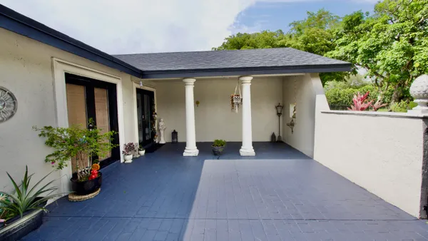 a view of a house with porch and furniture