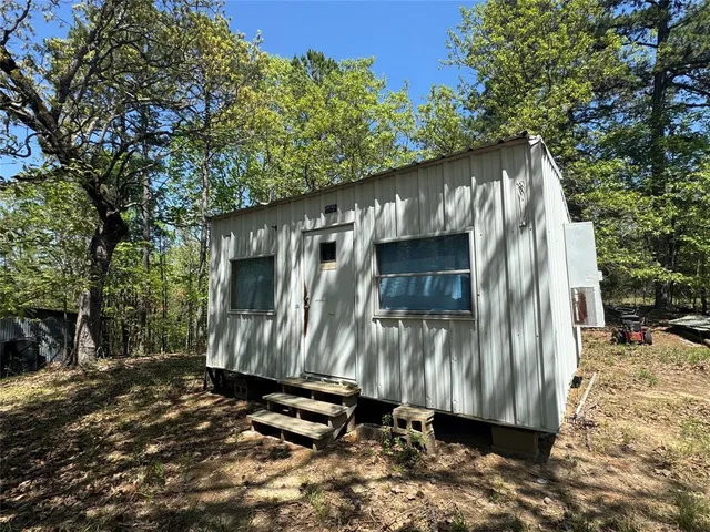a view of a wooden bench with trees in the background