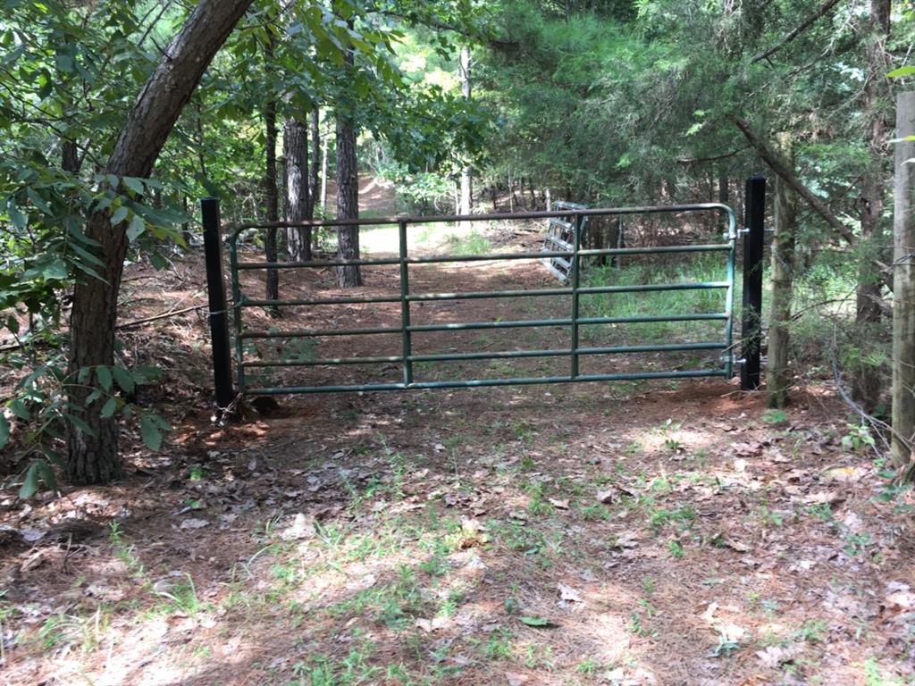 0 Tucker Road Fort Towson, OK 74735 - Photo 7 of 32 a view of a wooden bench with trees in the background