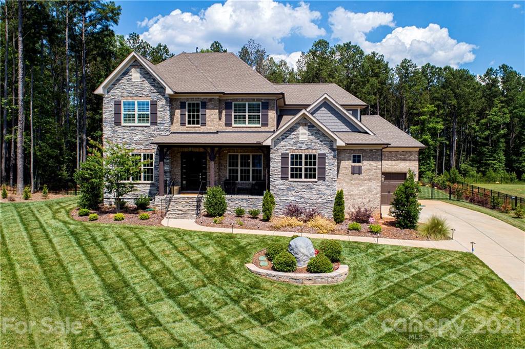 1286 Trinity Ridge Parkway Fort Mill, SC 29715 - Photo 2 of 48 a front view of a house with a yard table and chairs