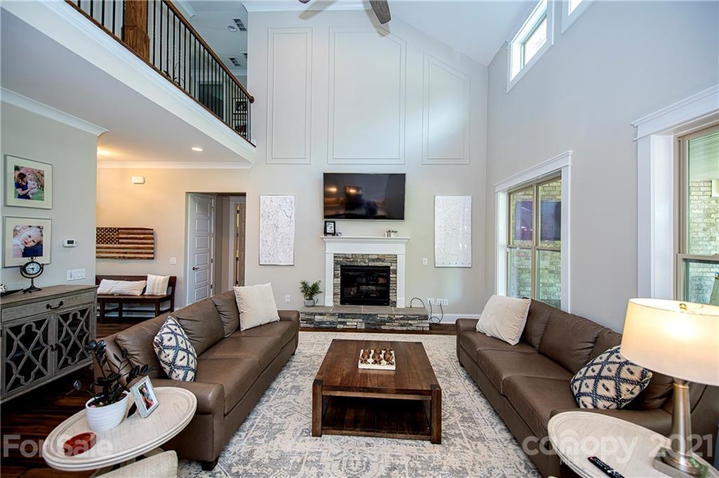 1286 Trinity Ridge Parkway Fort Mill, SC 29715 - Photo 17 of 48 a living room with furniture a fireplace a flat screen tv and a large window