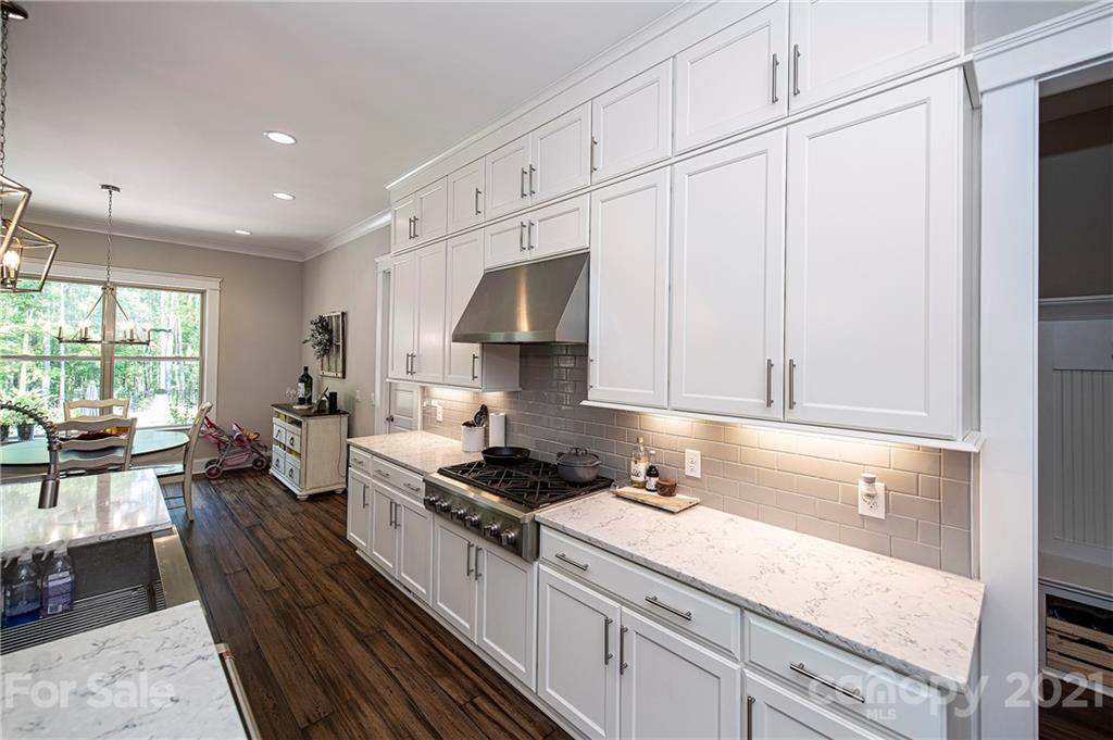 1286 Trinity Ridge Parkway Fort Mill, SC 29715 - Photo 21 of 48 a kitchen with granite countertop a sink a stove and cabinets