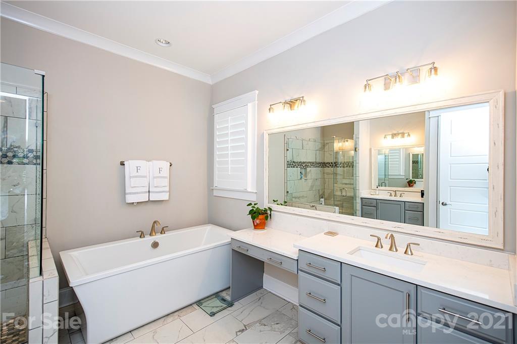 1286 Trinity Ridge Parkway Fort Mill, SC 29715 - Photo 28 of 48 a large white bathroom with a double vanity sink a large mirror a bathtub and next to a window