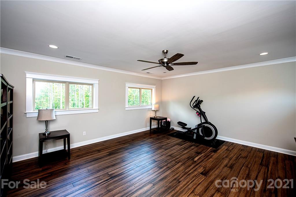 1286 Trinity Ridge Parkway Fort Mill, SC 29715 - Photo 36 of 48 a view of a room with wooden floor gym equipment and windows