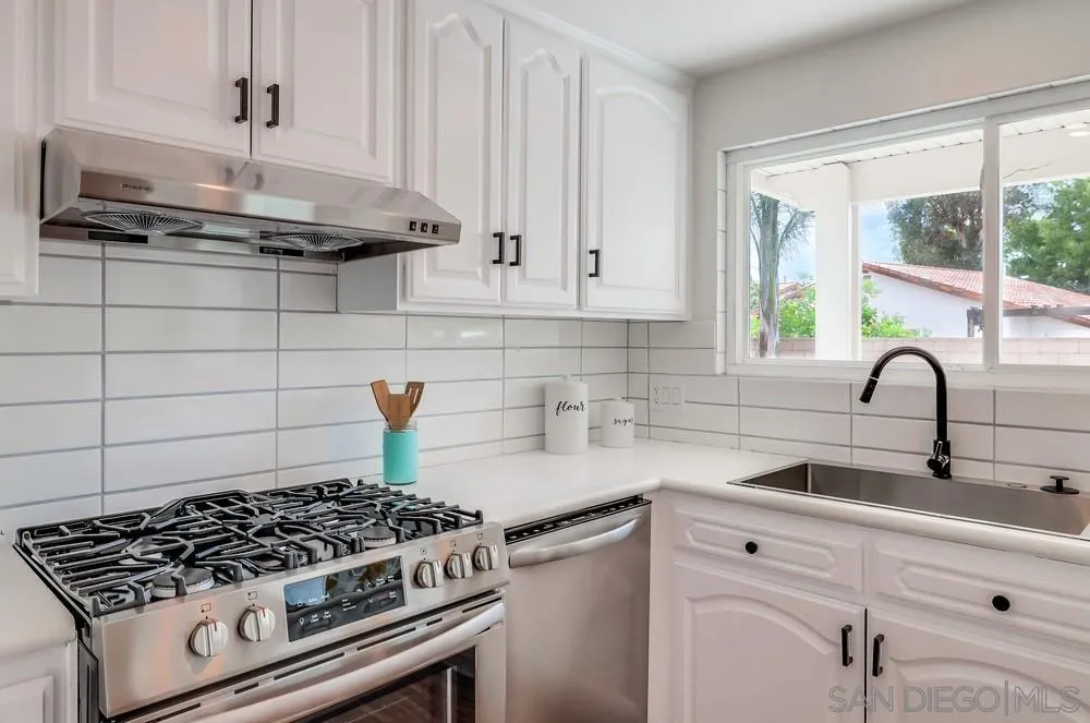13362 Carriage Road Poway, CA 92064 - Photo 15 of 39 a kitchen with sink a stove and a window