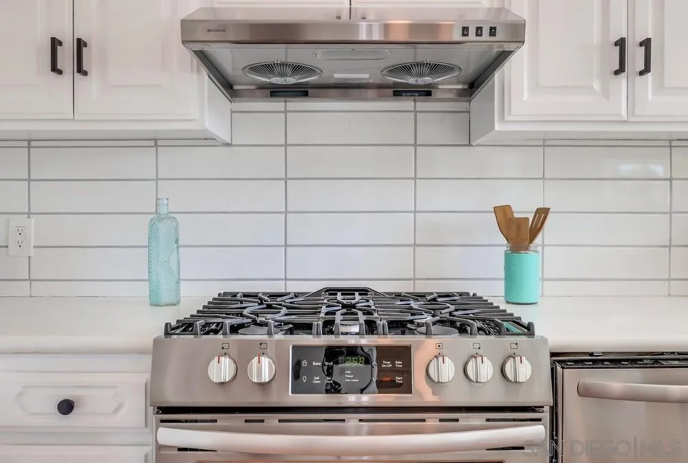 13362 Carriage Road Poway, CA 92064 - Photo 16 of 39 a stove top oven sitting inside of a kitchen