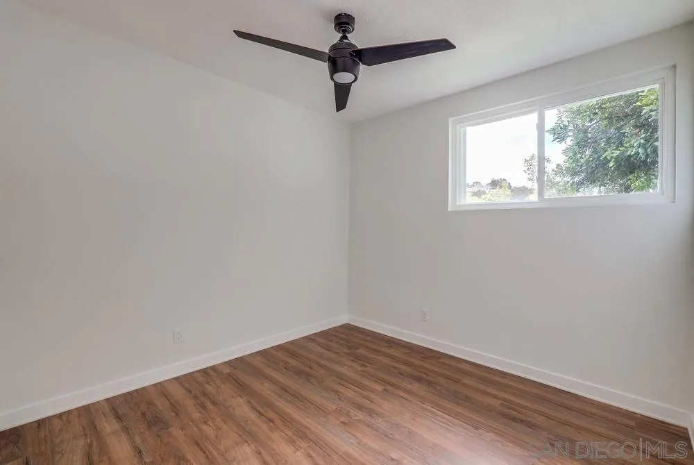 13362 Carriage Road Poway, CA 92064 - Photo 23 of 39 a view of empty room with wooden floor and fan