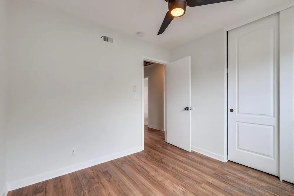 13362 Carriage Road Poway, CA 92064 - Photo 24 of 39 a view of an empty room with wooden floor
