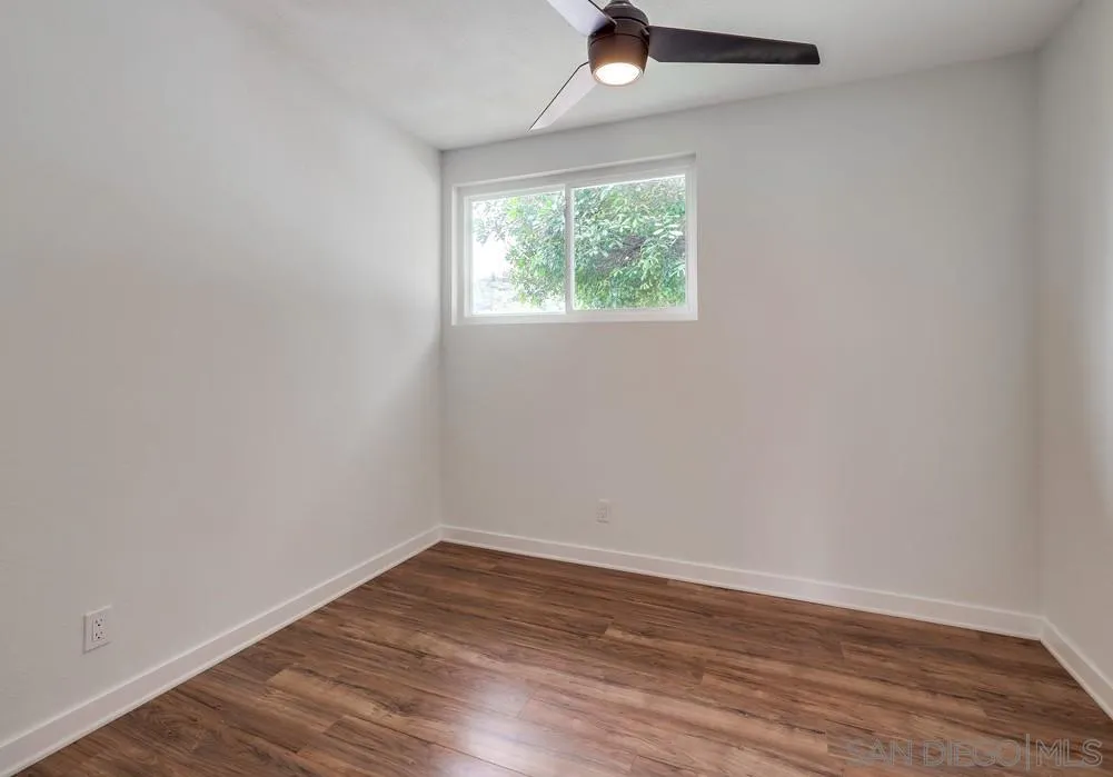 13362 Carriage Road Poway, CA 92064 - Photo 26 of 39 an empty room with wooden floor and windows