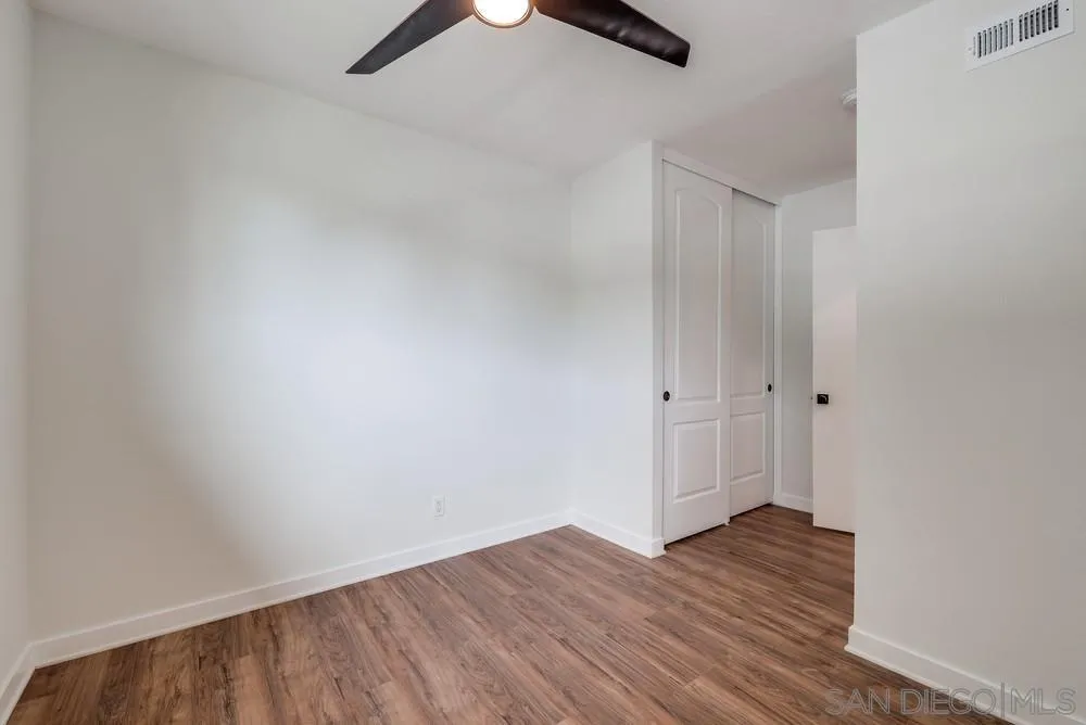 13362 Carriage Road Poway, CA 92064 - Photo 27 of 39 a view of an empty room with wooden floor