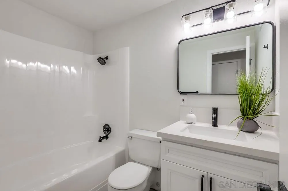 13362 Carriage Road Poway, CA 92064 - Photo 29 of 39 a bathroom with a toilet a sink a tub and mirror
