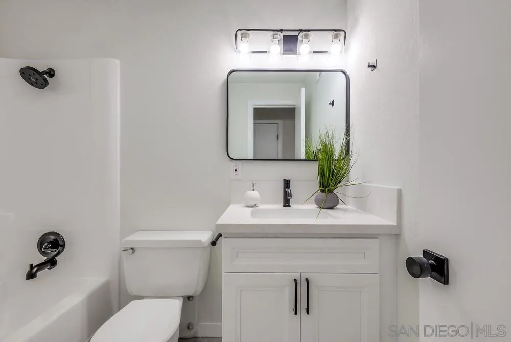 13362 Carriage Road Poway, CA 92064 - Photo 30 of 39 a bathroom with a toilet sink and mirror