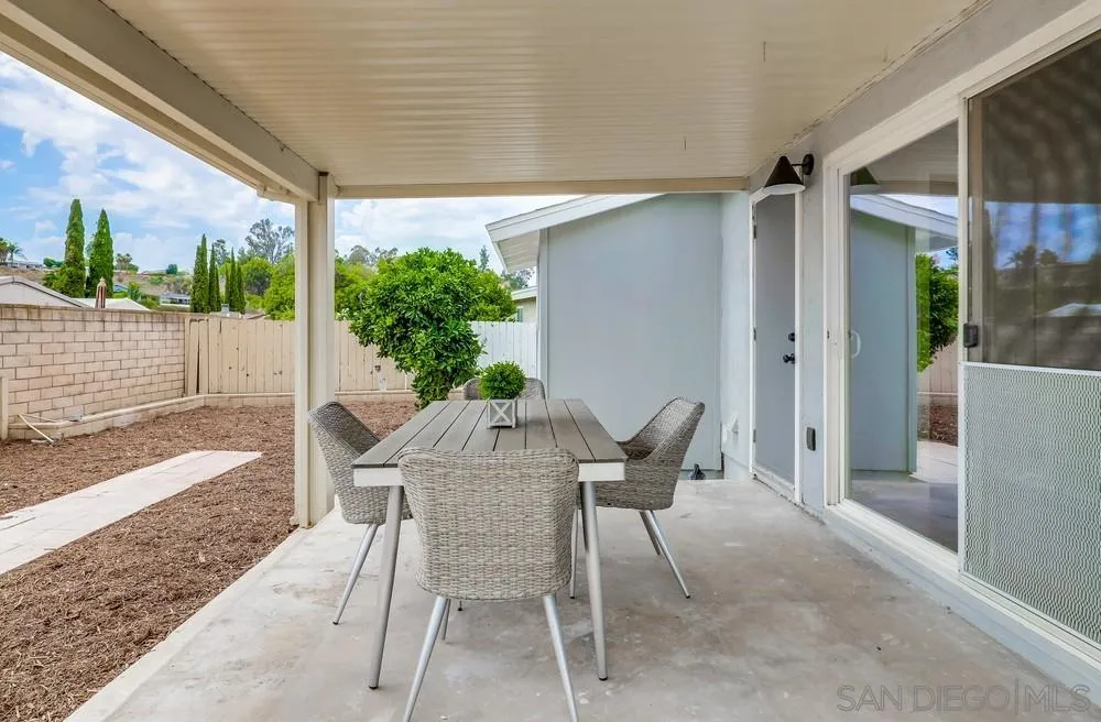 13362 Carriage Road Poway, CA 92064 - Photo 33 of 39 a view of a patio with table and chairs and potted plants