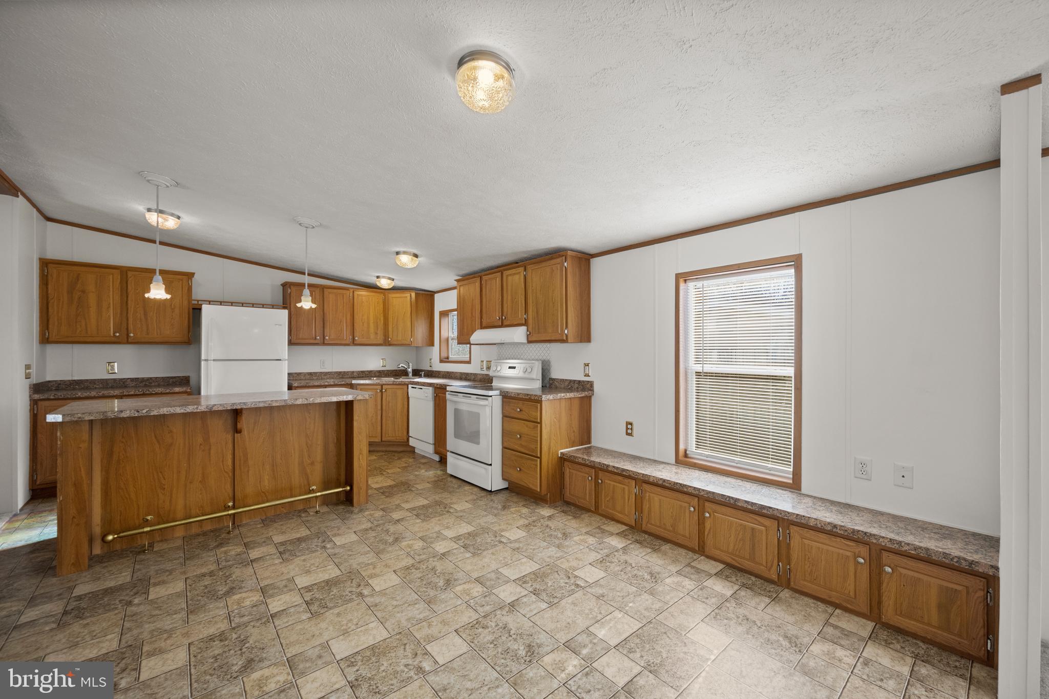 8408 Heartwood Road Jessup, MD 20794 - Photo 12 of 32 a large kitchen with a stove a sink dishwasher and a refrigerator