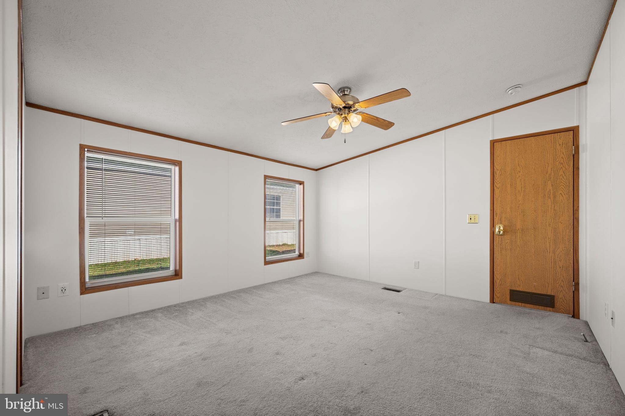 8408 Heartwood Road Jessup, MD 20794 - Photo 19 of 32 an empty room with windows and painted walls