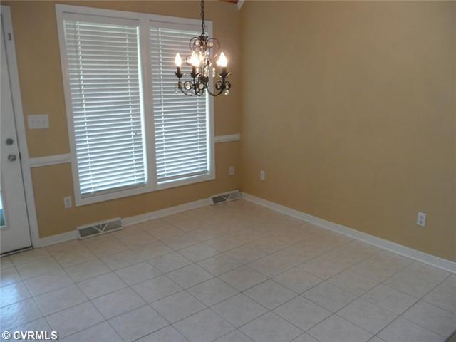541 Enon Church Road Chester, VA 23836 - Photo 3 of 12 Dining Room - Dining Area just off Kitchen offers Soaring Vaulted Ceilings, attractive light fixture, Ceramic Tile Flooring and door onto Rear Porch.