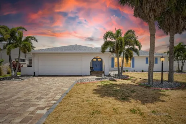 a view of a house with a yard and plant