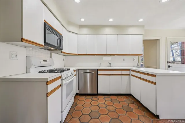 a kitchen with stainless steel appliances granite countertop a stove and a sink