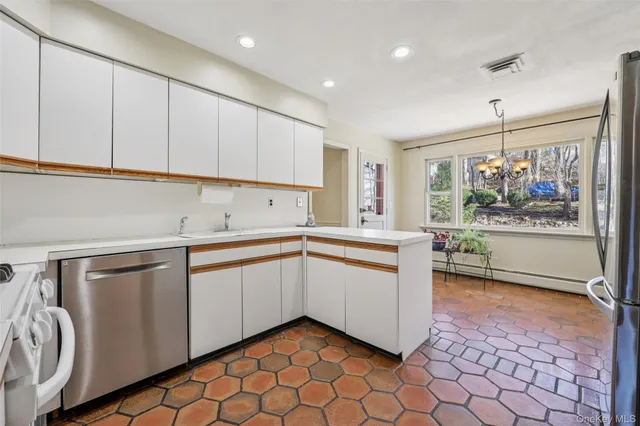 a kitchen with a sink cabinets and window