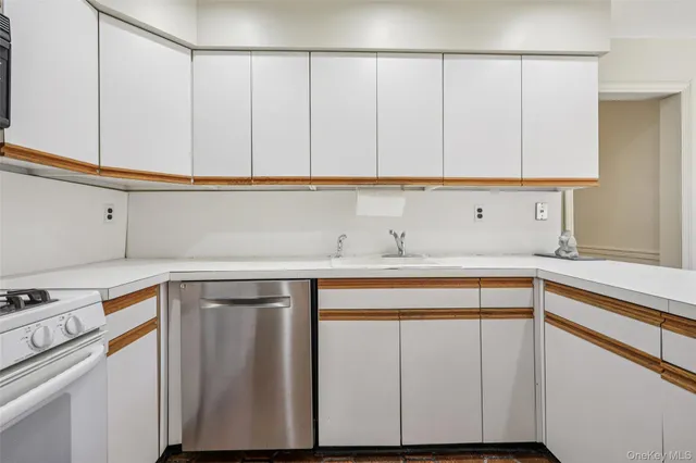 a kitchen with granite countertop white cabinets and white appliances