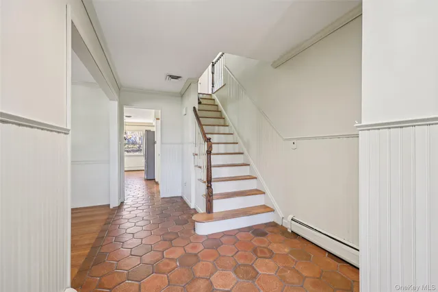 a view of entryway and hall with wooden floor