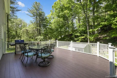 a view of a deck with table and chairs and wooden floor