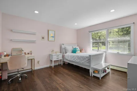 a room with a bed and large windows