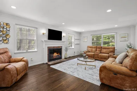 a living room with furniture fireplace and window