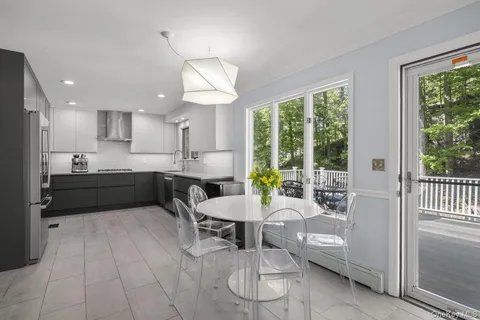 a kitchen with a table chairs refrigerator and microwave
