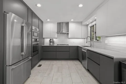 a kitchen with stainless steel appliances a refrigerator sink and cabinets