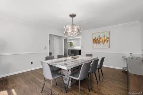 a view of a dining room with furniture wooden floor and chandelier